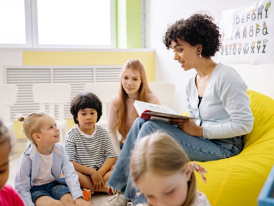 A Root Kids leader reading a story to children